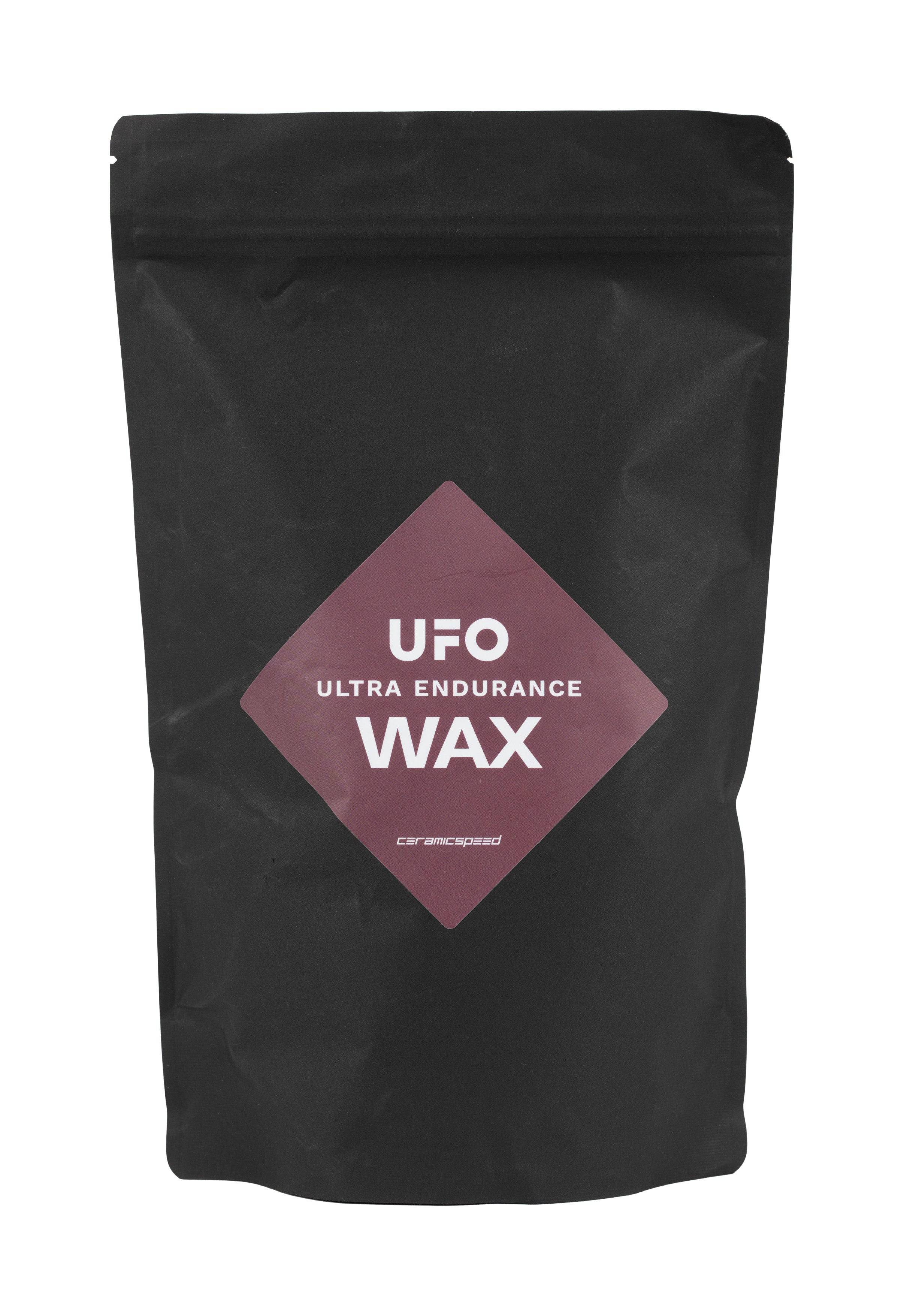 CeramicSpeed UFO Ultra Endurance Wax bag with chain lubricant for gravel racing, displayed in a workshop setting.