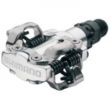 Shimano PD-M520 MTB SPD pedal with silver dual-sided clipless mechanism, durable mountain biking component.