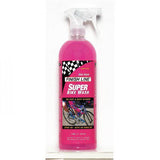 Finish Line Super Bike Wash eco-friendly bike cleaner in a workshop setting, showing a spray bottle and bike surface cleaning.