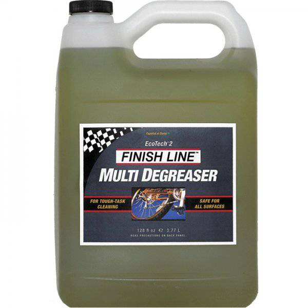 Finish Line EcoTech 2 biodegradable bike degreaser in a workshop setting, showing the eco-friendly cleaner bottle and workspace.
