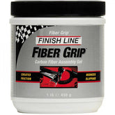 Finish Line Fiber Grip Carbon fiber assembly gel tub for bike components, used in workshop for secure, durable bike part assembly.