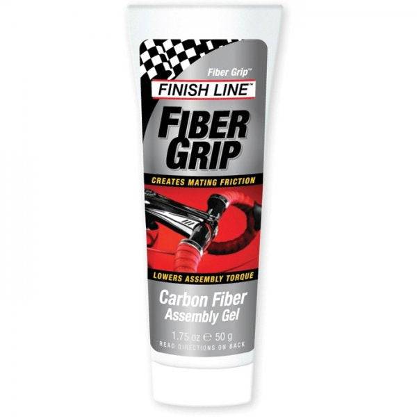 Finish Line Fiber Grip carbon fiber assembly gel for securing bike components, shown in a workshop setting.