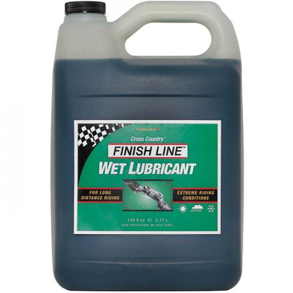 Finish Line Wet Chain Lube for cross country bikes, shown in a workshop setting, ideal for wet, muddy conditions, 1-gallon size.