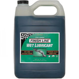Finish Line Wet Chain Lube for cross country bikes, shown in a workshop setting, ideal for wet, muddy conditions, 1-gallon size.