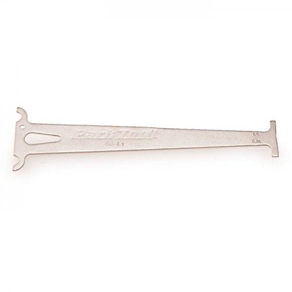 Park Tool CC-3.2 chain wear indicator gauge used on 10-speed bike chains for accurate measurement in bike workshop.