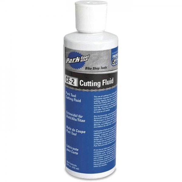 Park Tool CF-2 cutting fluid for metalworking, red liquid reduces friction and extends tool life in workshop use.