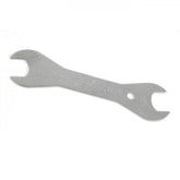 Park Tool DCW-3 double-ended cone wrench with 17mm and 18mm tips for bicycle wheel maintenance, workshop tool in use.