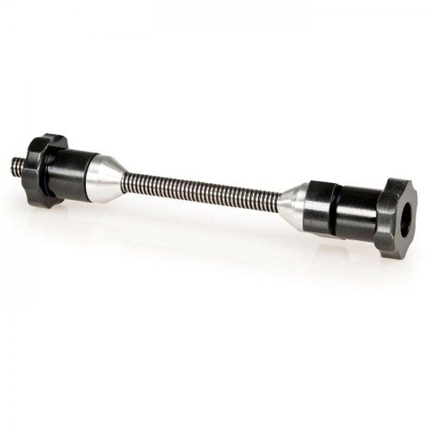 Park Tool TSTA thru-axle adapter for wheel truing stands, suitable for 12, 15, and 20mm bike axles in workshop setting.