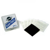 Park Tool GP-2 super patch kit with self-adhesive patches and sandpaper for bike tire repairs in a workshop setting.