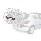 Thule 976 Light Board accessory for bike racks with rear lights and visible number plate, mounted on a vehicle for safety.