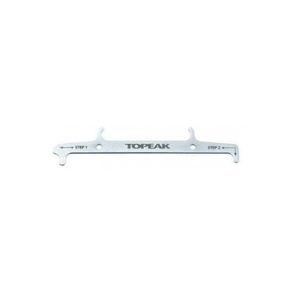Topeak silver chain hook and wear indicator tool for accurate bike chain measurement, used in bike workshop settings.