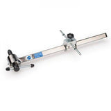 Park Tool DAG-2.2 derailleur hanger alignment gauge for precise bike adjustments, shown in a workshop setting.