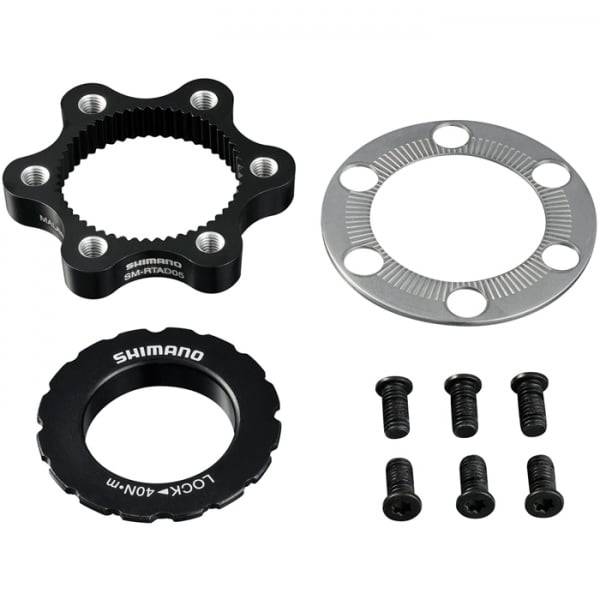 Shimano SM-RTAD05 6-bolt rotor to centre-lock hub disc brake adapter for bicycle components, shown mounted on a bike wheel.