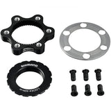 Shimano SM-RTAD05 6-bolt rotor to centre-lock hub disc brake adapter for bicycle components, shown mounted on a bike wheel.
