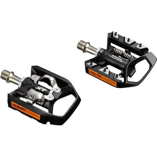 Shimano XT MTB SPD trekking pedals with single-sided clipless platform and rugged metal construction for mountain biking.