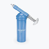 Park Tool GG-1 grease gun for precise lubrication, shown with workshop setup and Park Tool compounds.