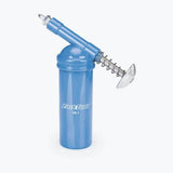 Park Tool GG-1 grease gun for precise lubrication, shown with workshop setup and Park Tool compounds.
