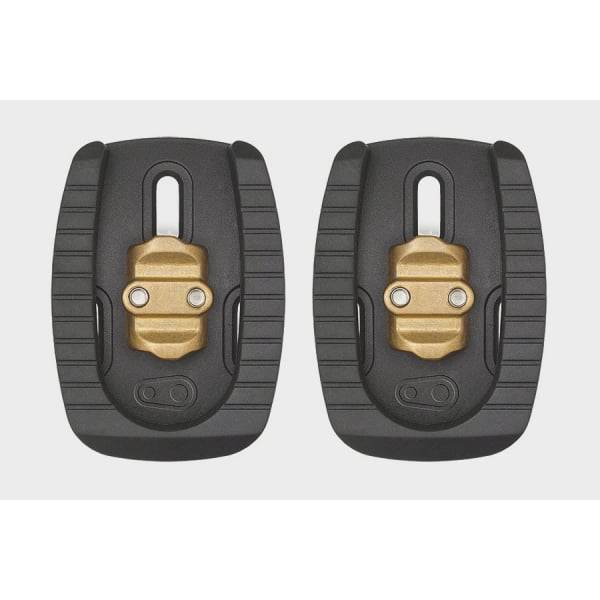 Black Crankbrothers Quattro cleat for 3-bolt road shoes, compatible with Eggbeater and Candy pedals, shown mounted on cycling shoe.