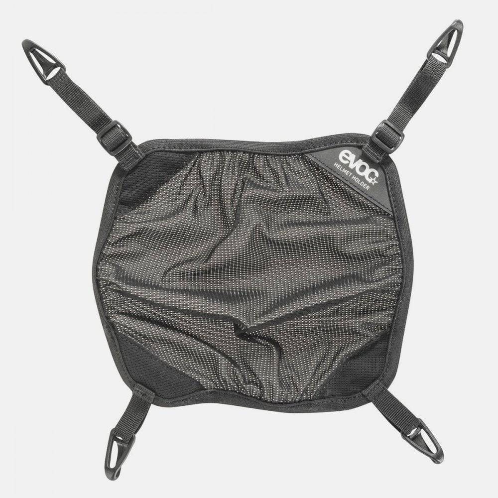 Black EVOC helmet holder, adjustable backpack accessory designed for winter sports and biking helmet transport.