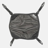 Black EVOC helmet holder, adjustable backpack accessory designed for winter sports and biking helmet transport.