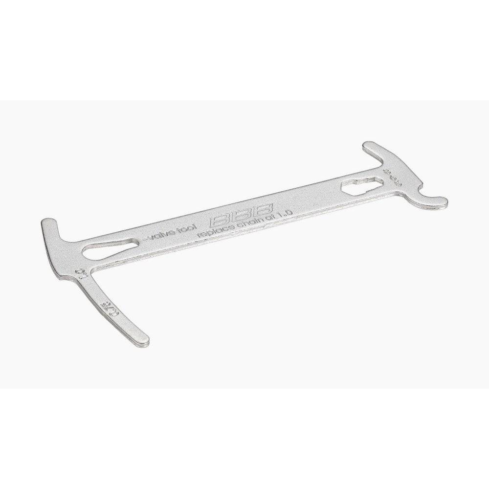 BBB BTL-125 ChainChecker wear gauge with valve tool and hex wrenches for bike maintenance, displayed on a workshop surface.