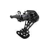 Shimano Deore RD-M5100 11-speed MTB rear derailleur with Shadow+ technology and long cage, mounted on a mountain bike.
