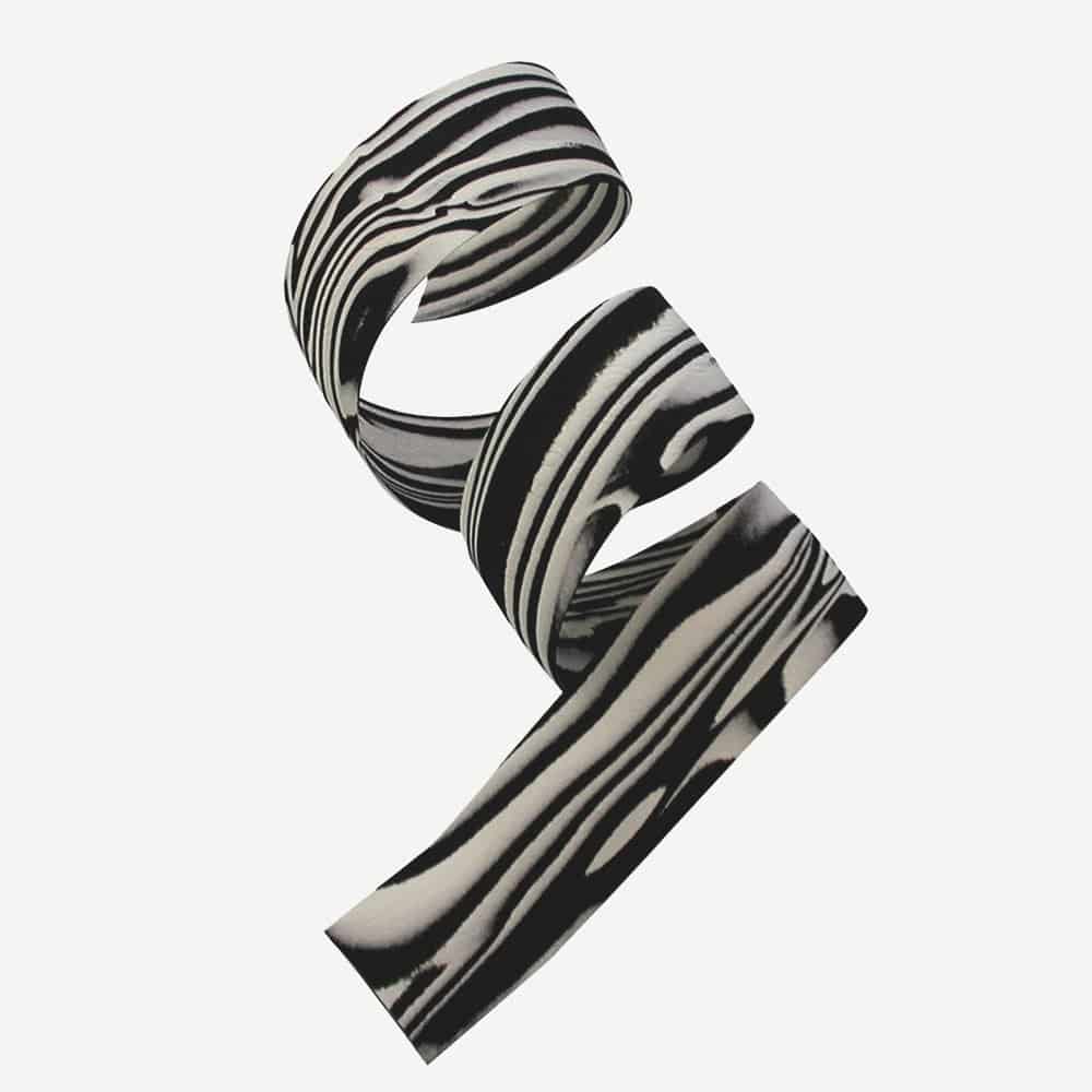 Cinelli Zebra cork cycling bar tape with matching logo bar end plugs, designed for comfortable grip and stylish bike handlebar finish.