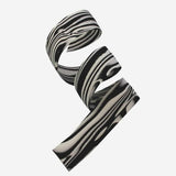 Cinelli Zebra cork cycling bar tape with matching logo bar end plugs, designed for comfortable grip and stylish bike handlebar finish.