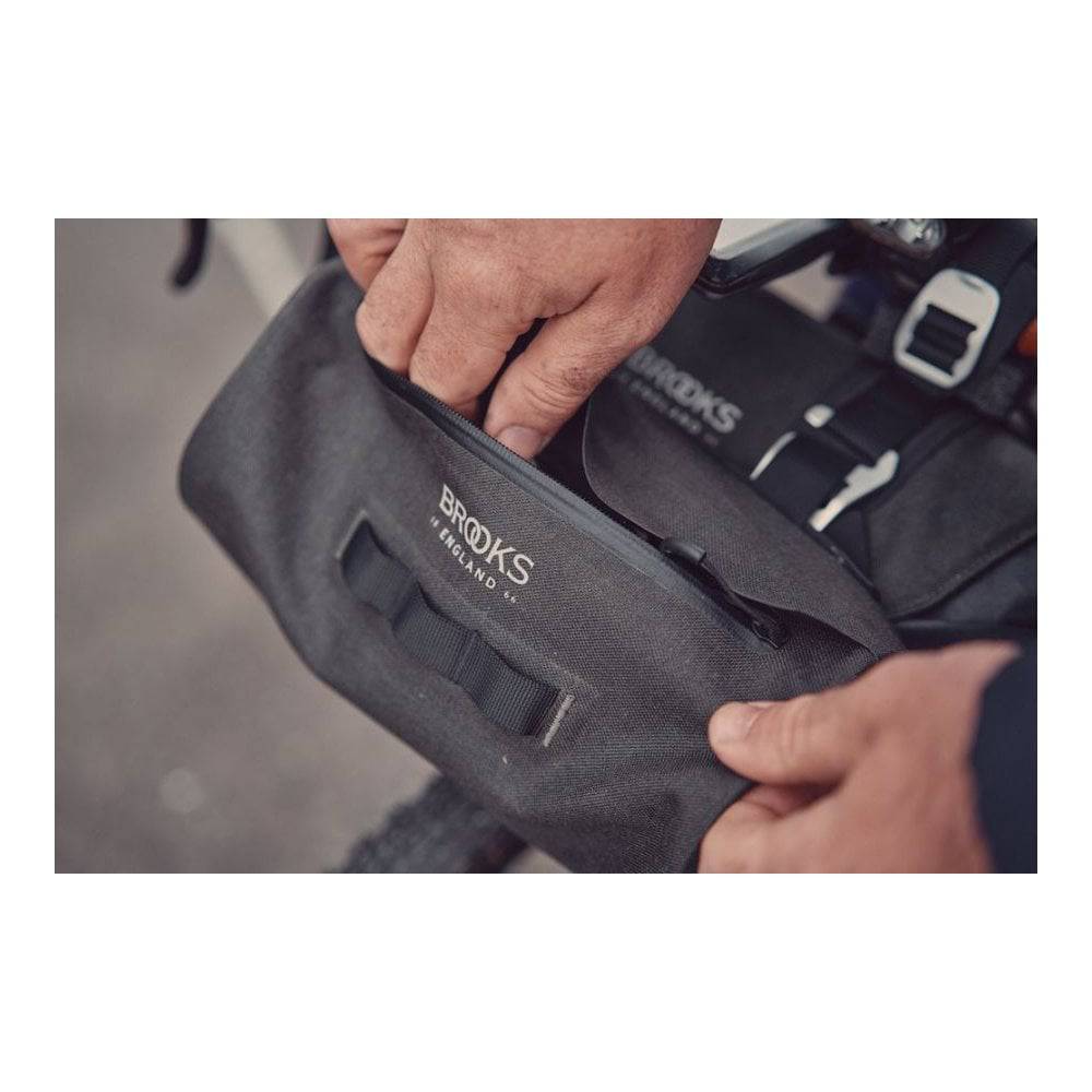 Brooks Scape waterproof handlebar pouch in mud green, bike storage bag with secure strap attachment for cycling accessories.