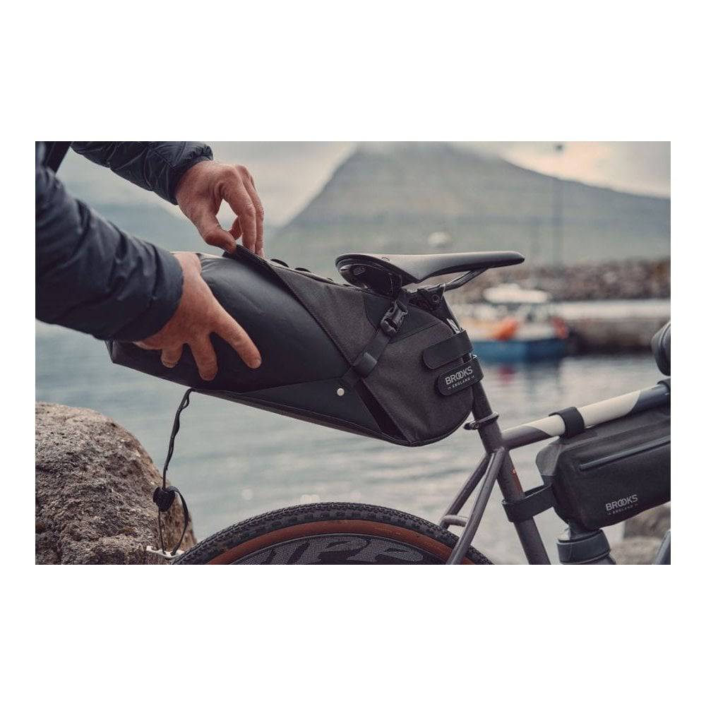 Brooks Scape Seat Bag in muddy green waterproof bikepacking drybag with daisy chain attachment and adjustable straps.