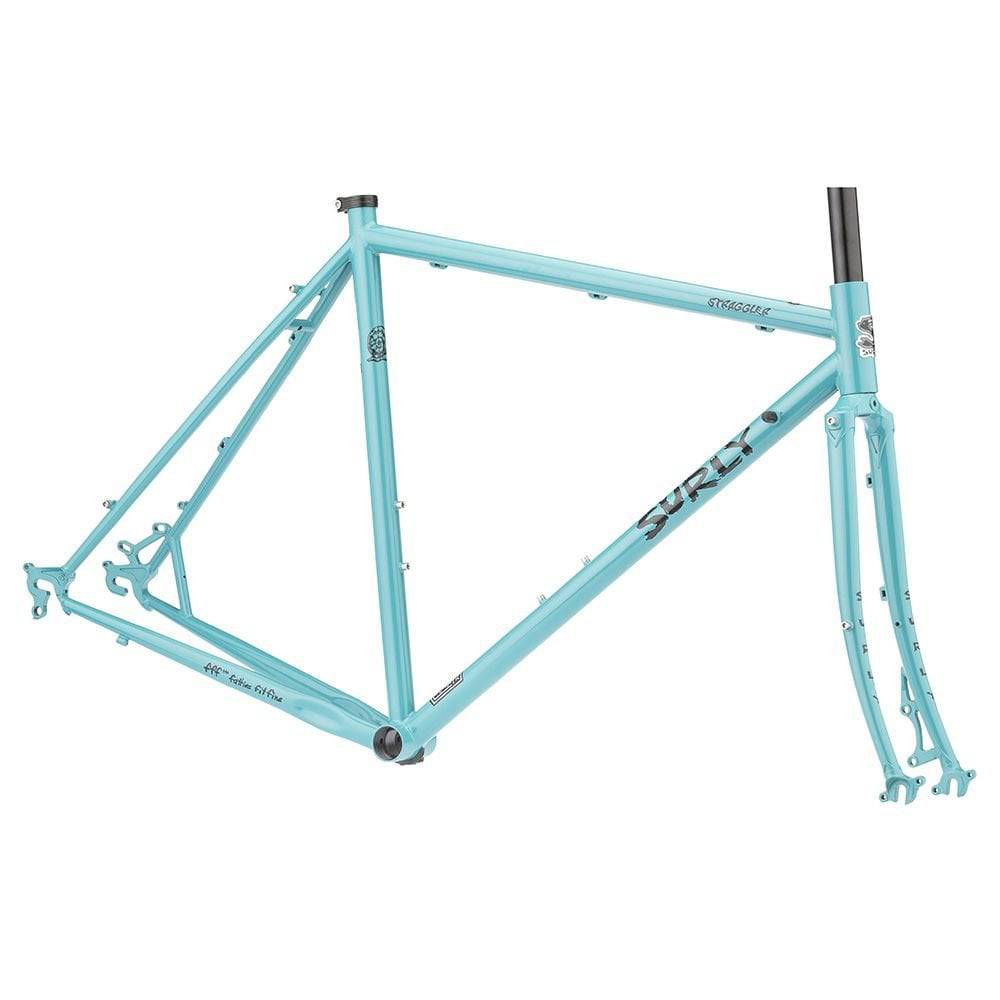 Surly Straggler steel road bike frameset with touring and commuting features, shown in a natural outdoor setting.