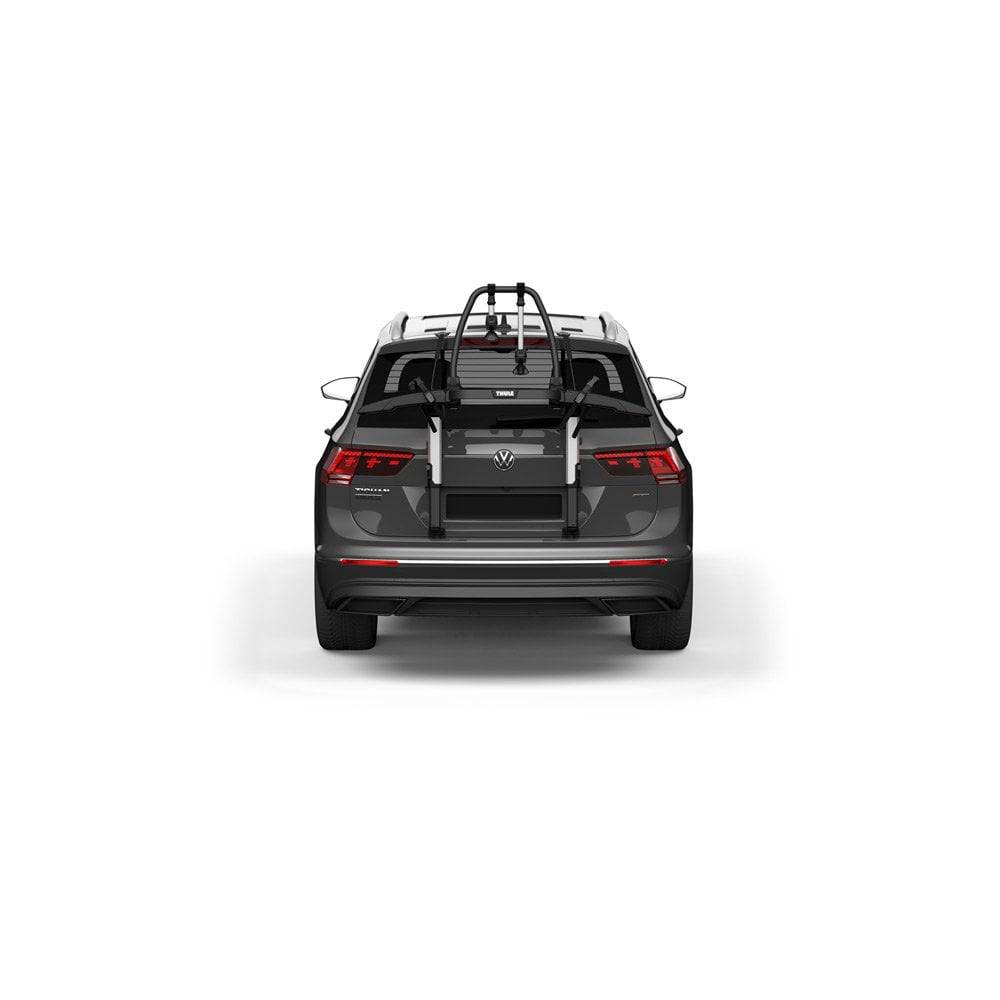 Thule OutWay rear-mount platform bike carrier with two bike slots and lockable cables for secure transport.