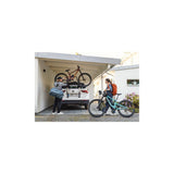 Thule OutWay rear-mount platform bike carrier with two bike slots and lockable cables for secure transportation.