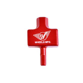 Wheels Manufacturing Fox DHX2 and FLOAT X2 shock adjuster tool with hex wrench slots, used in bike workshop maintenance.