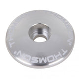 Silver Thomson 1 1/8 bike stem cap for securing bike stems and seatposts, shown on a white background.