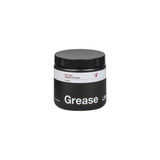 Bontrager bicycle grease lubricant for waterproof, low friction, and carbon fiber bike maintenance, shown in a workshop setting.