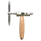 Lezyne Classic Chain Drive Nickel adjustable chain tool with ergonomic wooden handle, used for bike chain repair in workshop.