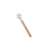 Lezyne Classic Pedal Rod 15mm wrench with bottle opener, used for bike pedal adjustments in a workshop setting.