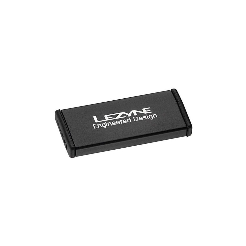 Lezyne Metal Patch Kit with waterproof aluminium case for quick tyre repairs, shown in a workshop setting.