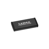 Lezyne Metal Patch Kit with waterproof aluminium case for quick tyre repairs, shown in a workshop setting.