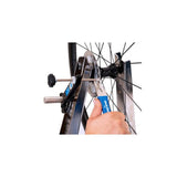Park Tool DT-2 rotor truing fork for precise disc brake rotor adjustment in a workshop setting.