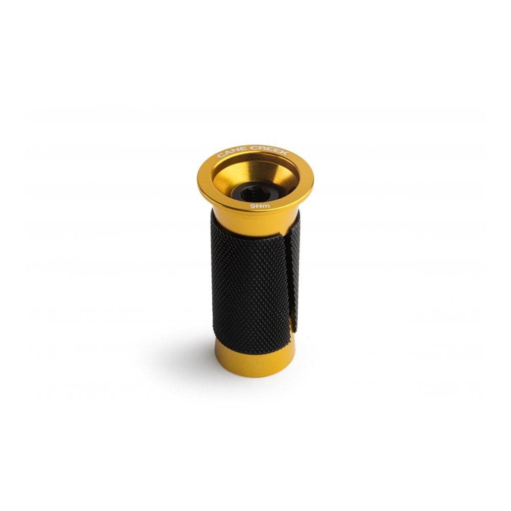Cane Creek Ancora expander plug for carbon steerer tubes, black and gold, used in bicycle component installations.