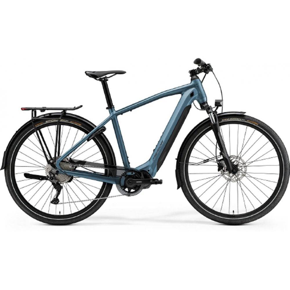 Merida eSpresso 500 EQ urban e-hybrid bike with Shimano STEPS motor and accessories, shown outdoors with a city background.