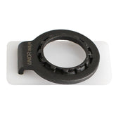 UNIOR 2-in-1 bike spoke and cassette lockring tool for maintenance, shown in a workshop setting with metal tools.