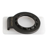 UNIOR 2-in-1 bike spoke and cassette lockring tool for maintenance, shown in a workshop setting with metal tools.