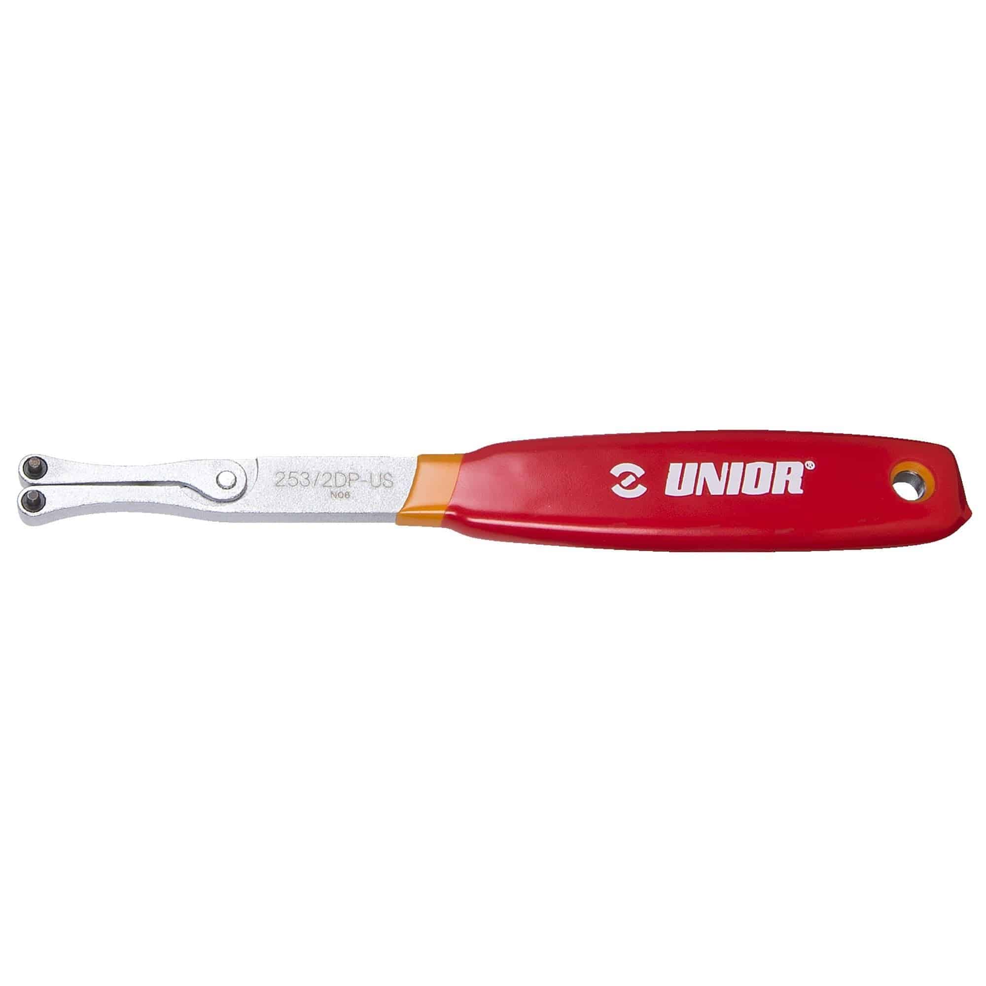 Red UNIOR adjustable spanner wrench with interchangeable 2.3mm and 3.8mm pins for workshop use, shown with tools in the image.
