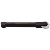 UNIOR Pro Chain Wear Indicator Tool for bike chain measurement, showing the tool with measurement markings in a workshop setting.