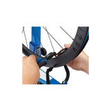 Park Tool CSH-1 clamping spoke holder for wheel truing and spoke tensioning in a workshop setting.