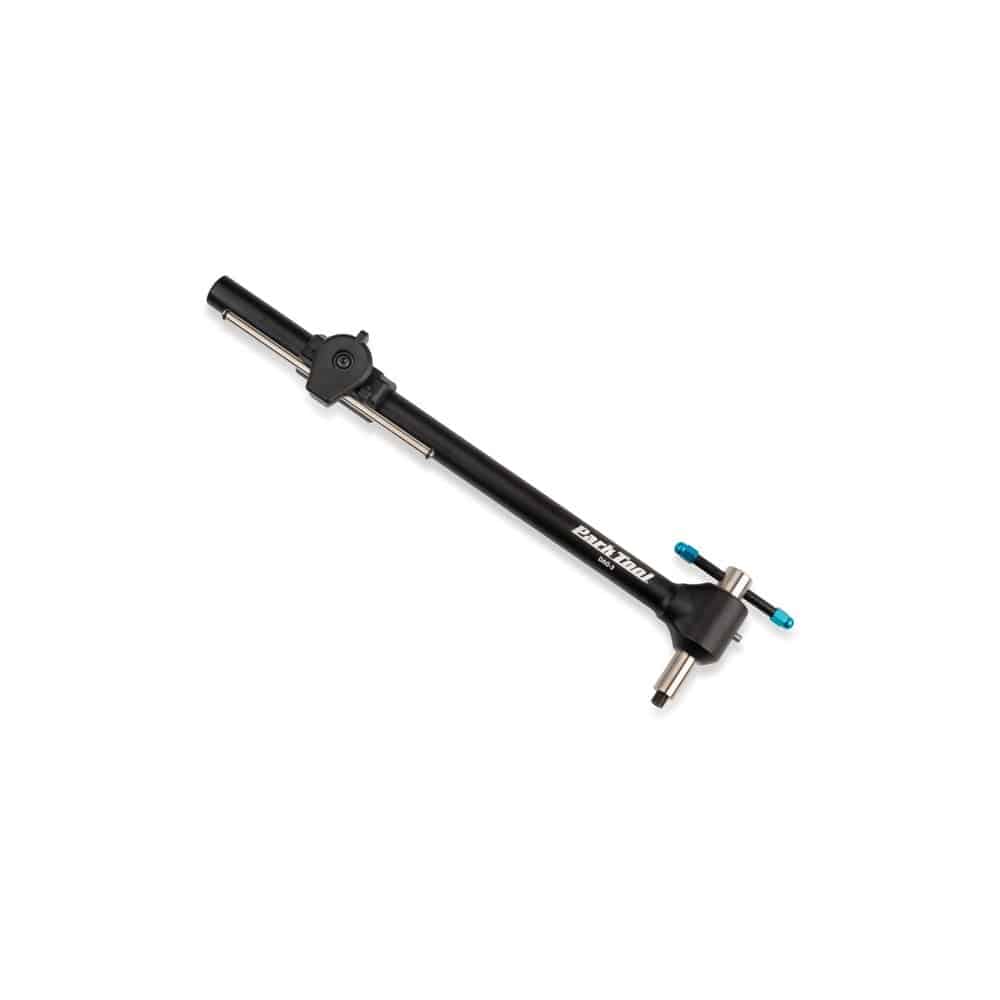 Park Tool DAG-3 derailleur hanger alignment gauge used in bike workshop for precise derailleur alignment and bike repairs.