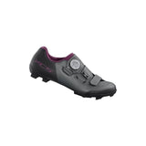 Shimano XC5W women's MTB shoes with SPD cleats, cross-country mountain biking shoes, black with blue accents, designed for cycling.